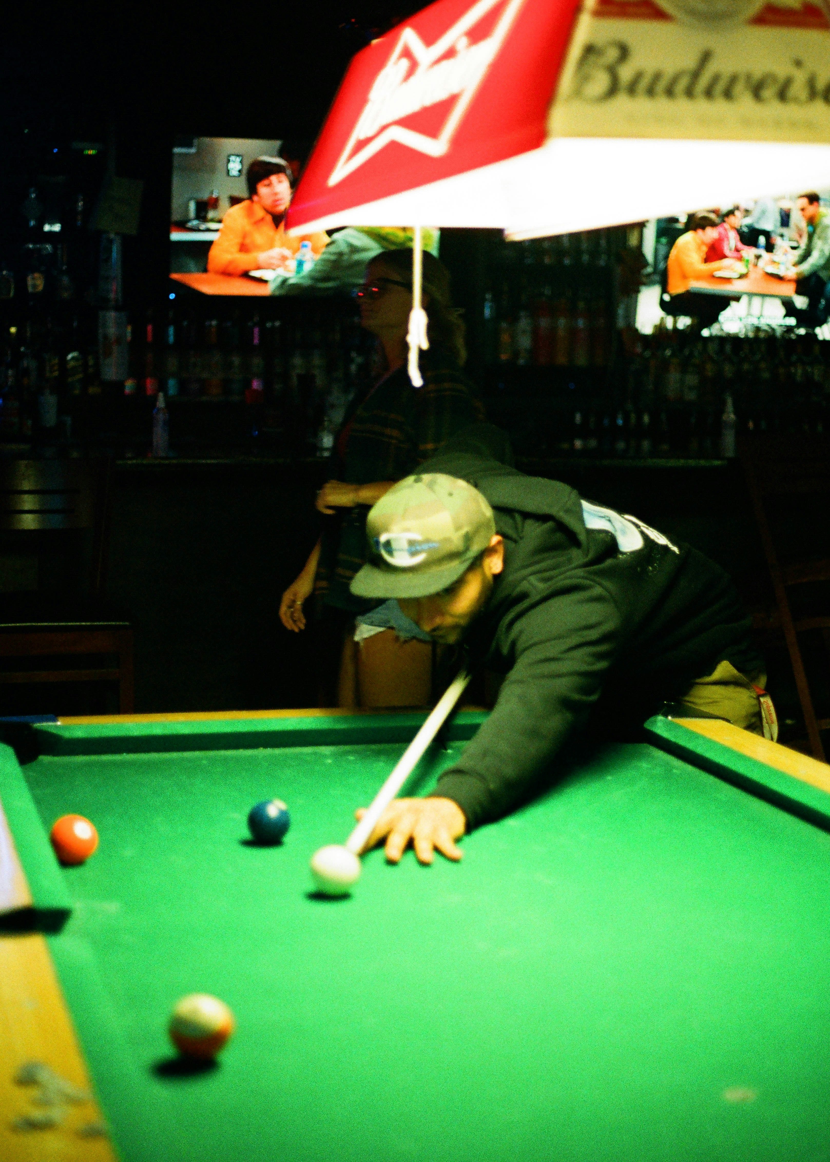 man in black long sleeve shirt playing billiard